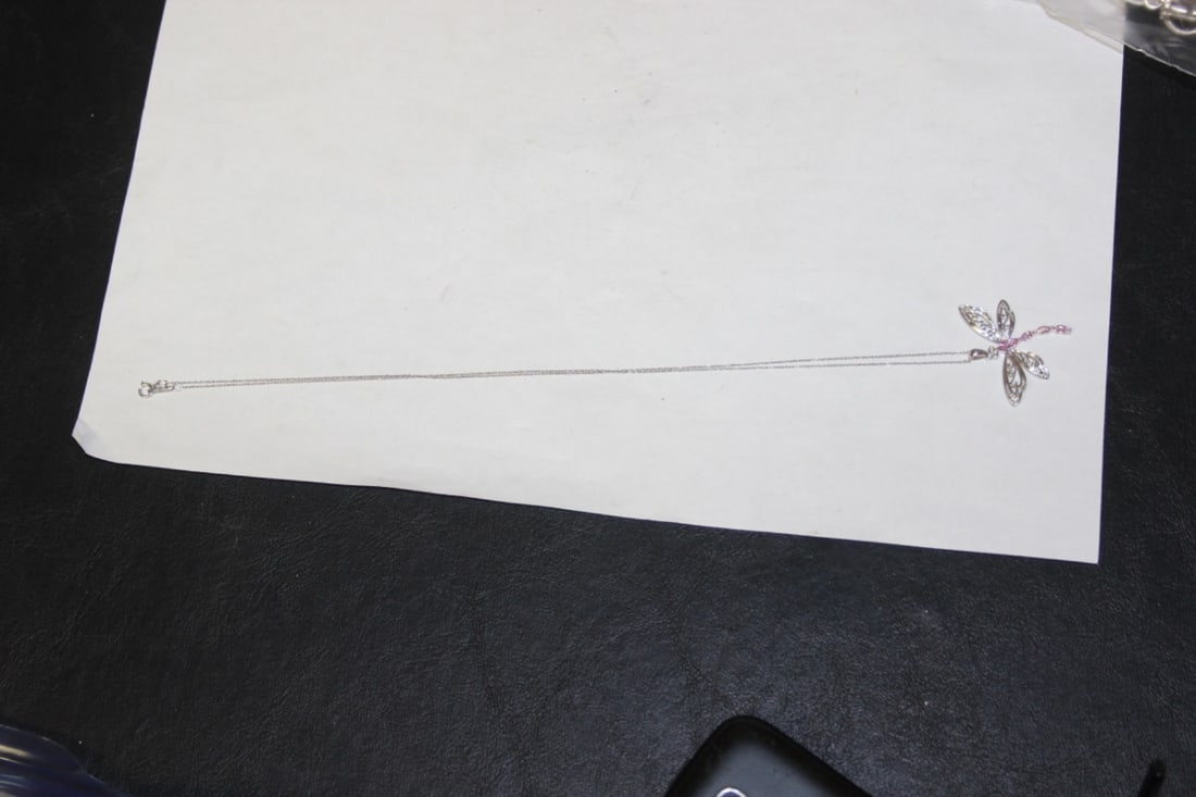 A 10Kt Gold Dragonfly Pendant: with most likely saphire gemstones - pendant is marked and has been tested - overall 10" long - very nice work