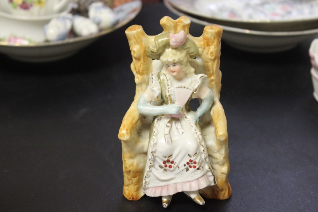A Seated Ceramic Figure: 19th/20th Century - please note manufacturer defect on the back - 5 1/4 inches tall
