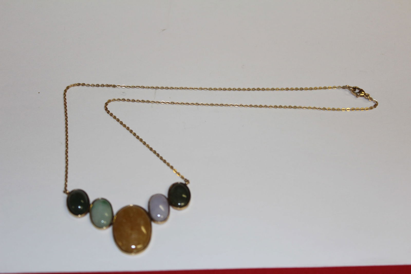 14k Gold Jade Pendant: 9" long when clasped. 11.1 grams. Unmarked but tested as 14k.