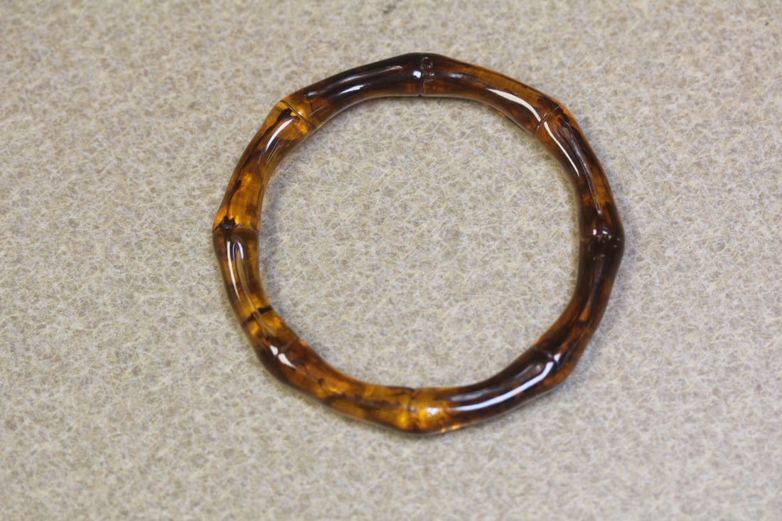 Lucite Bangle Bracelet: amber style bamboo motief - inside diameter= 2 1/2" - swirl design