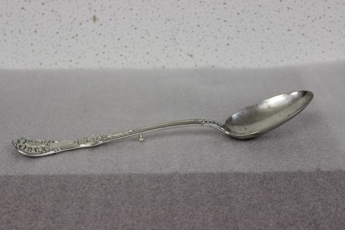 A Sterling Tiffany and Company Serving Spoon: over 8 ounces in weight and 12 1/2" long