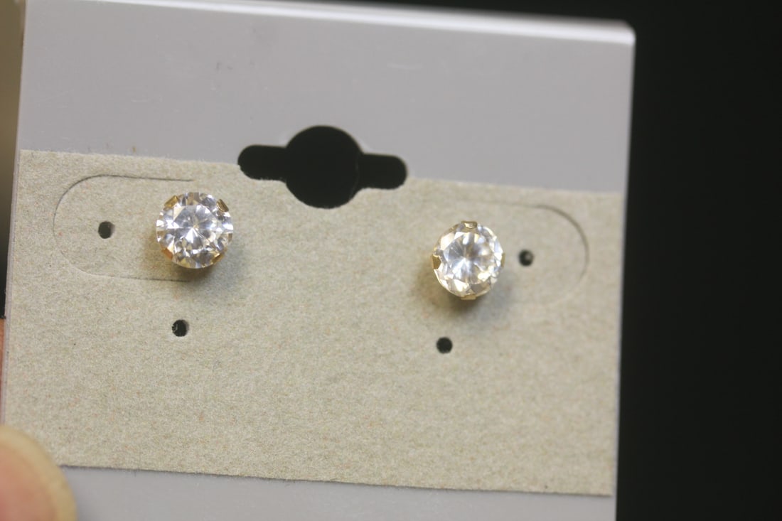 Pair of 14Kt and CZ Earrings: please note: one has a replacement back