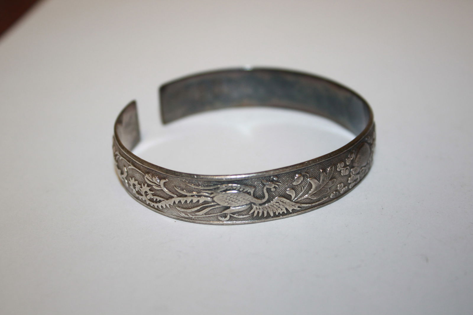 A Chinese Carved Bracelet: possibly sterling - has some Chinese writing on it as shown