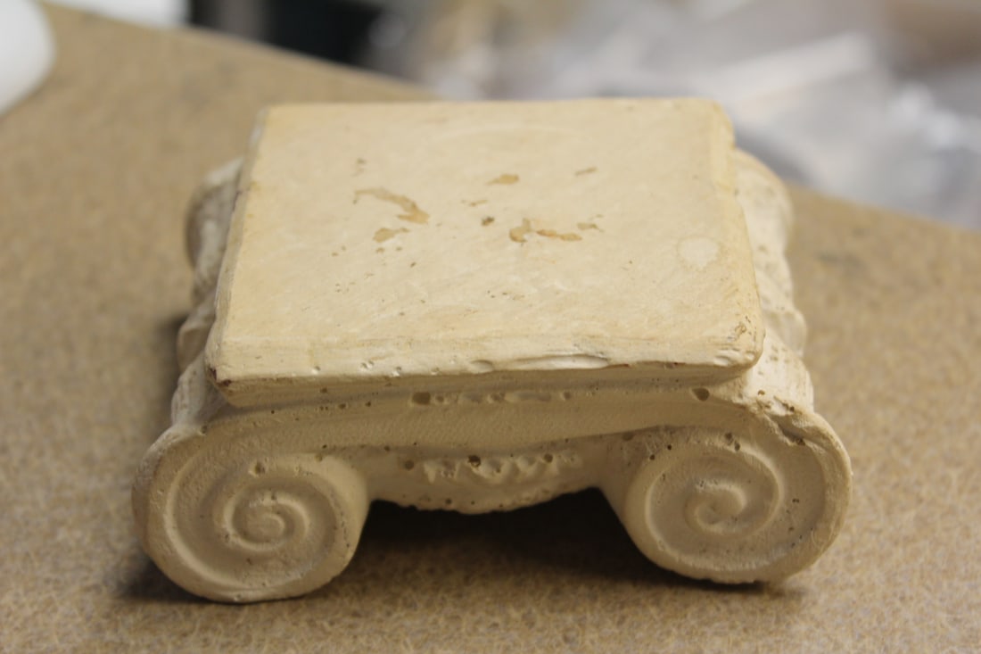 A Plastic or Chalk Stand: flat part = 3 inches square