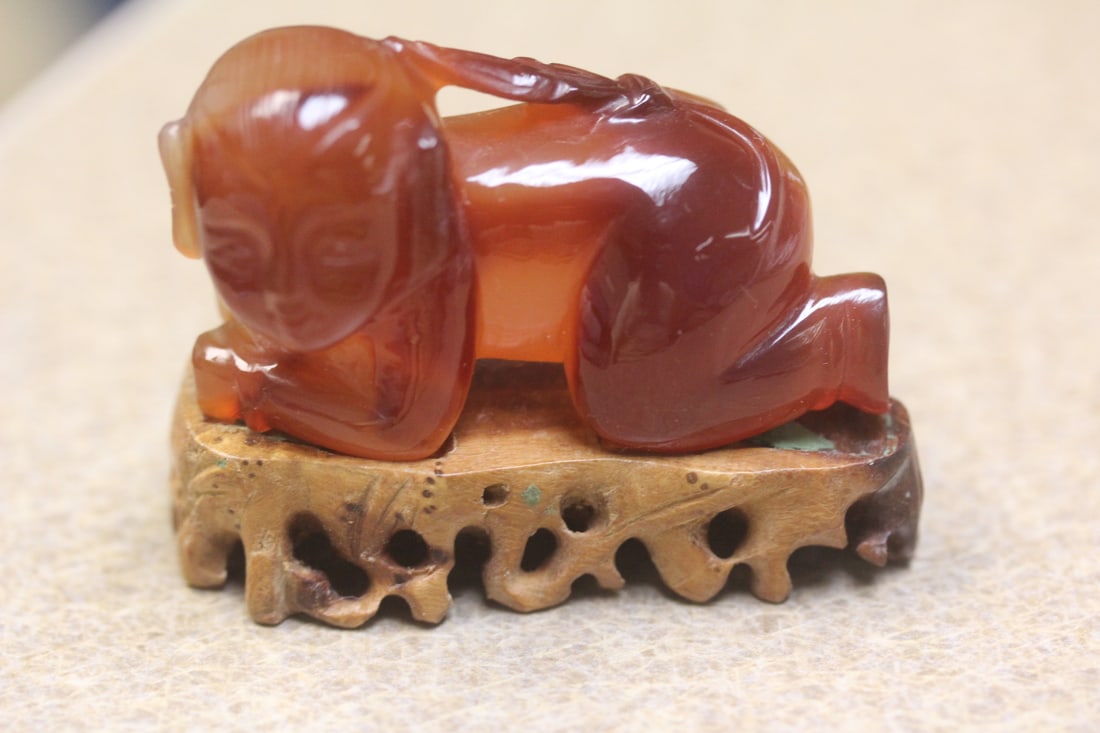Chinese Carving of a Boy: most likely agate - on stand - most likely mid 20th century - Chinese - 2 1/4" across