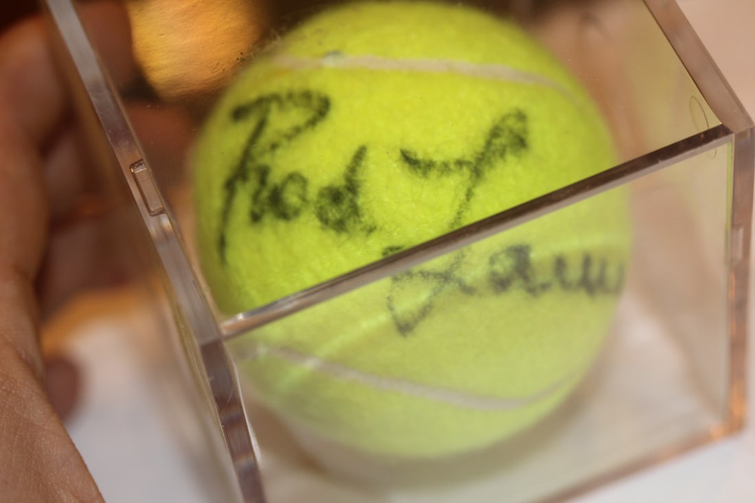 Signed Rod Laver Tennis Ball: inside a lucite cube