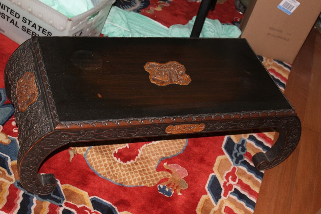 Antique Chinese Well Carved Low Scroll Table: Circa early 20th century. 38 1/2" x 16 1/2" x 12". Makers mark label on the back. Most likely camphor wood.