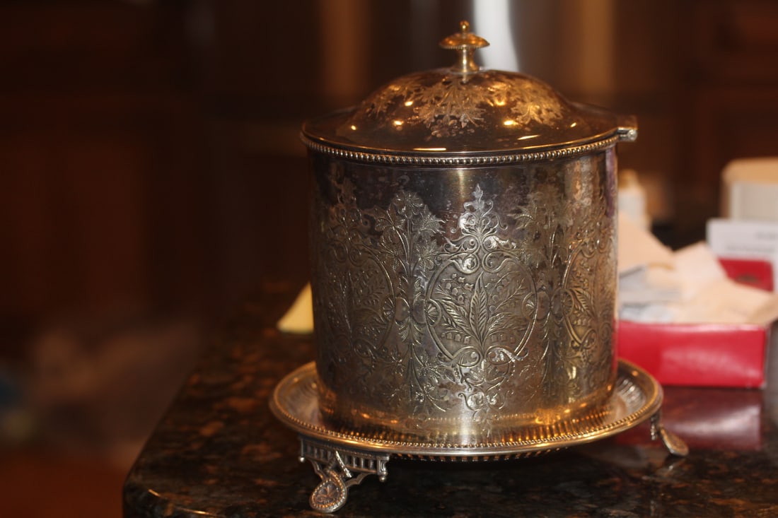 An Ornate Silverplate Container: 3-legged - 8 inches tall - most likely 19th century - beautiful display piece, just needs a little polishing