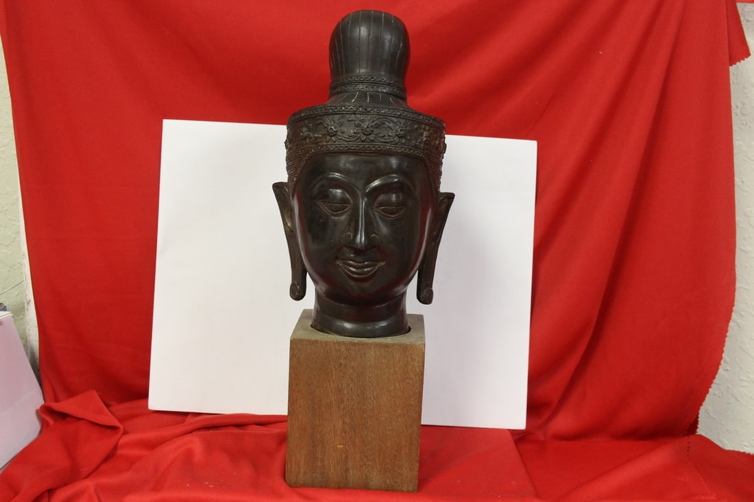 A Bronze Buudha Head: 9 1/2" tall without the stand - 14 inches with it - good patina