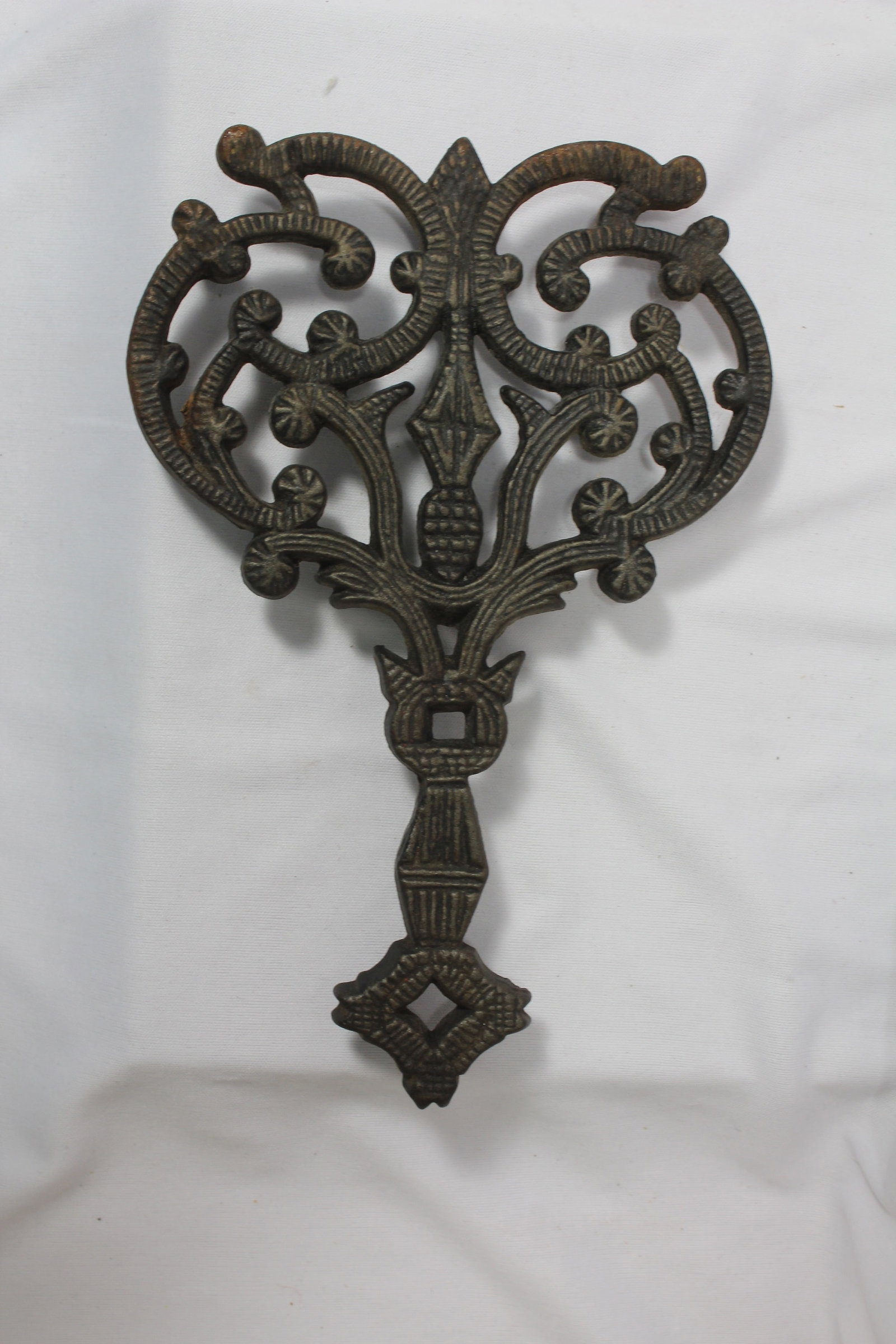 A Wilton Cast Iron Trivet: 6" wide