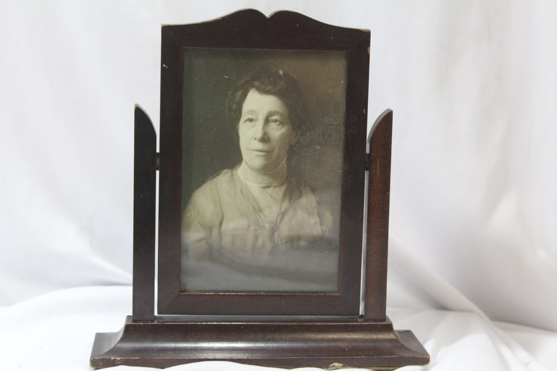 A Black and White Photo or Print of a Lady: possibly Native American - - inside a swivel frame - overall= 8 1/4" tall - inside measurement of the frame= 5 5/8" X 3 3/4"