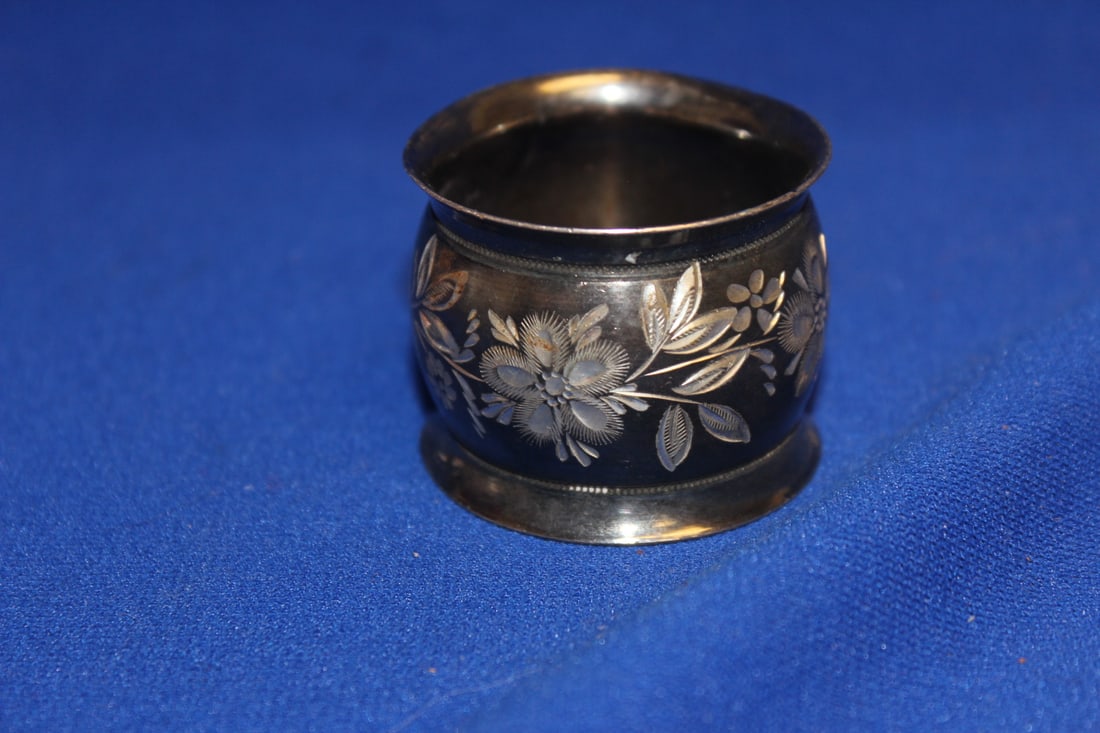 A Silverplated Single Napkin Ring: well carved