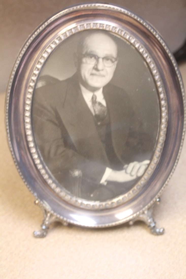 Sterling Picture Frame: oval - probably 1950's to 1960;s - approximately 10" in length overall - can fit a pictures size of 7 inches in diameter