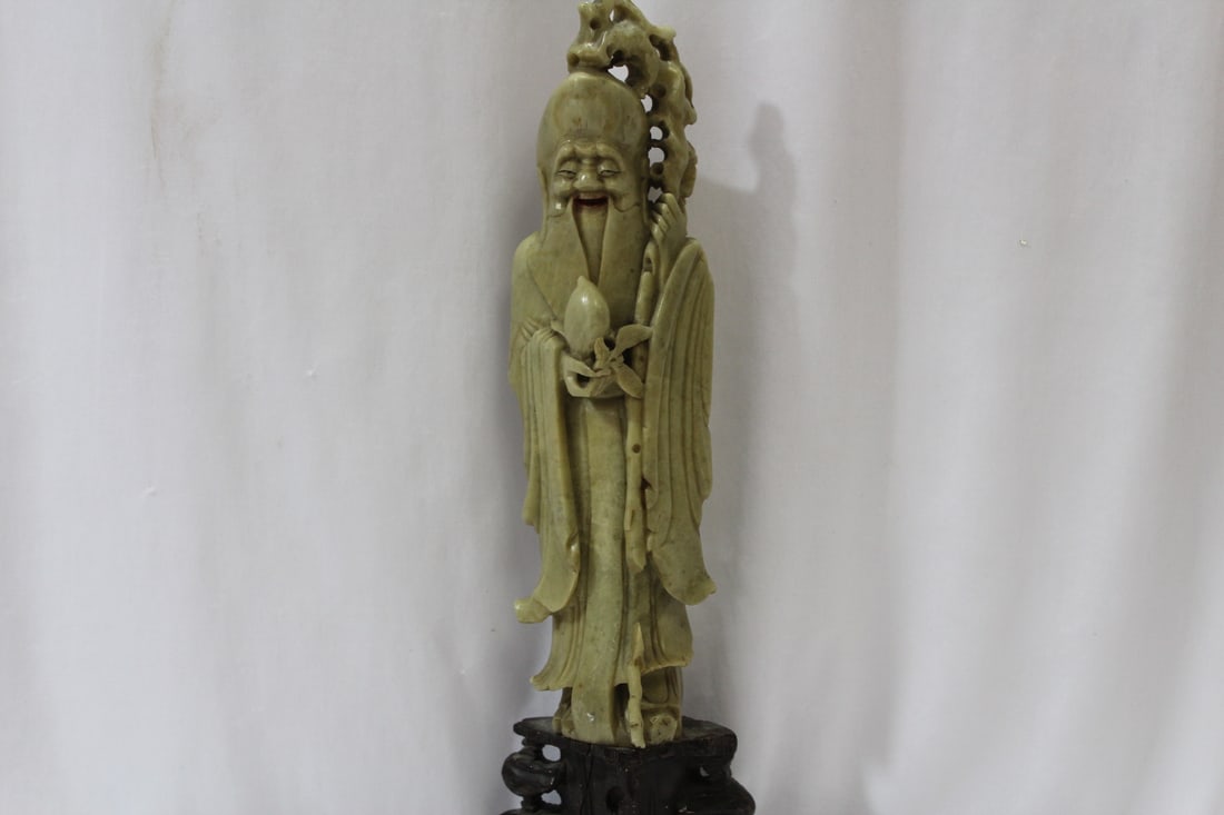 A Large Soapstone Figurine: please note: crack and losses - 15 inches tall