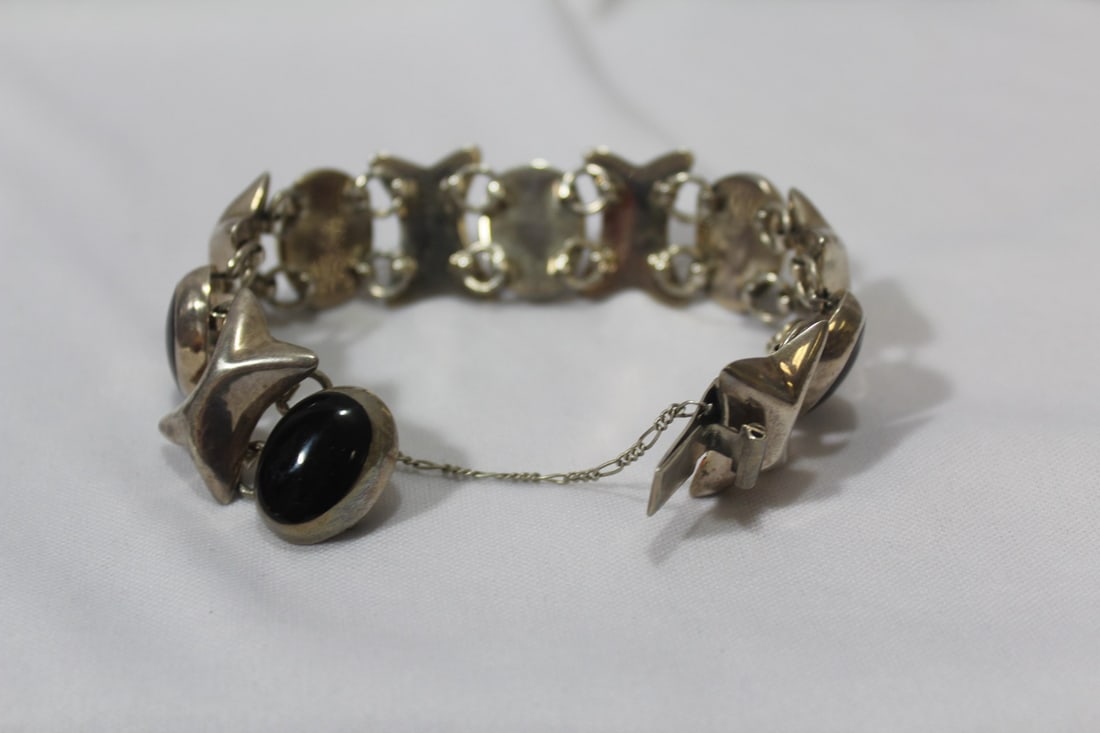 A Sterlign and Onyx Bracelet: approximately 2 1/2" inside diameter