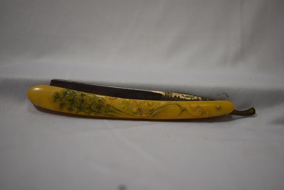 A Bakelite Handle Razor: 6" long