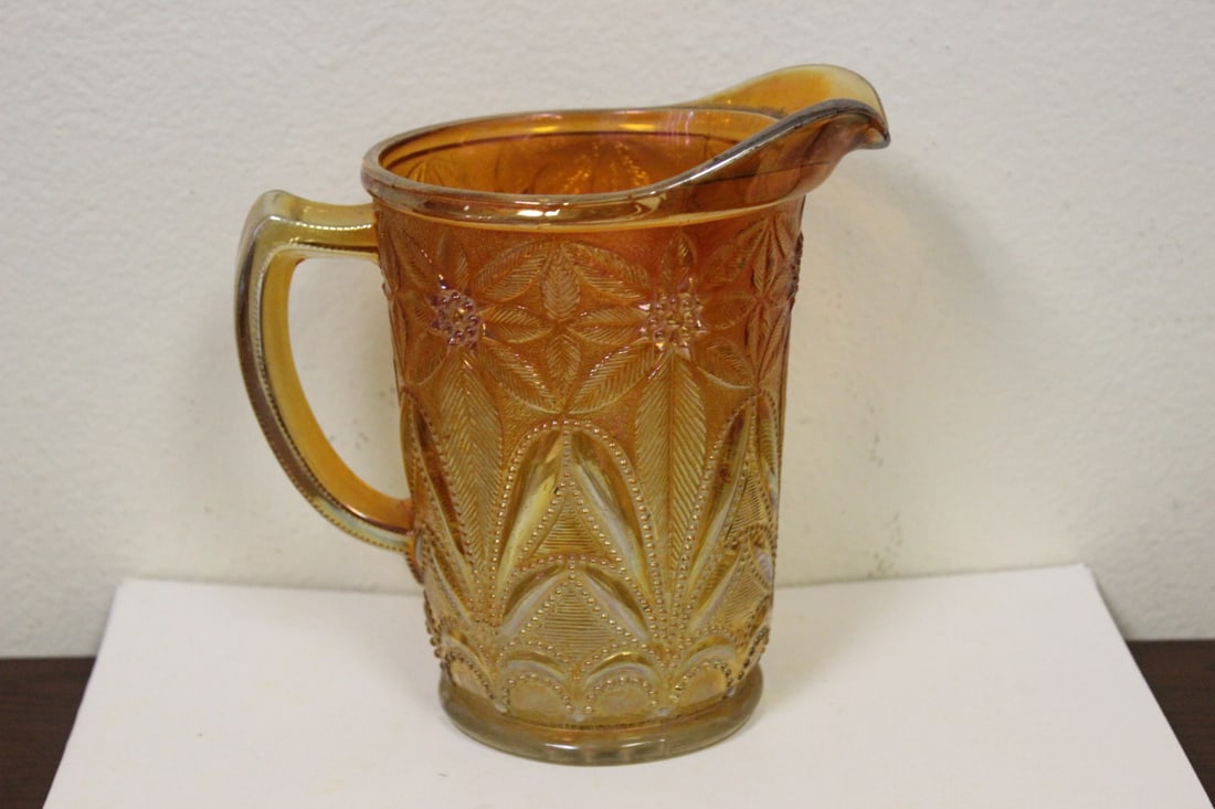 A Carnival Glass Pitcher: 6 1/2" tall - please note: manufacturer's defect on spout