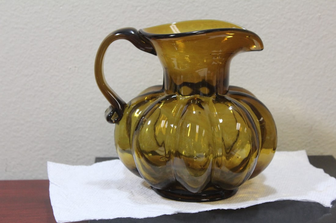 An Amber Glass Water Pitcher: handblown - ribbed design - 6 1/2" tall