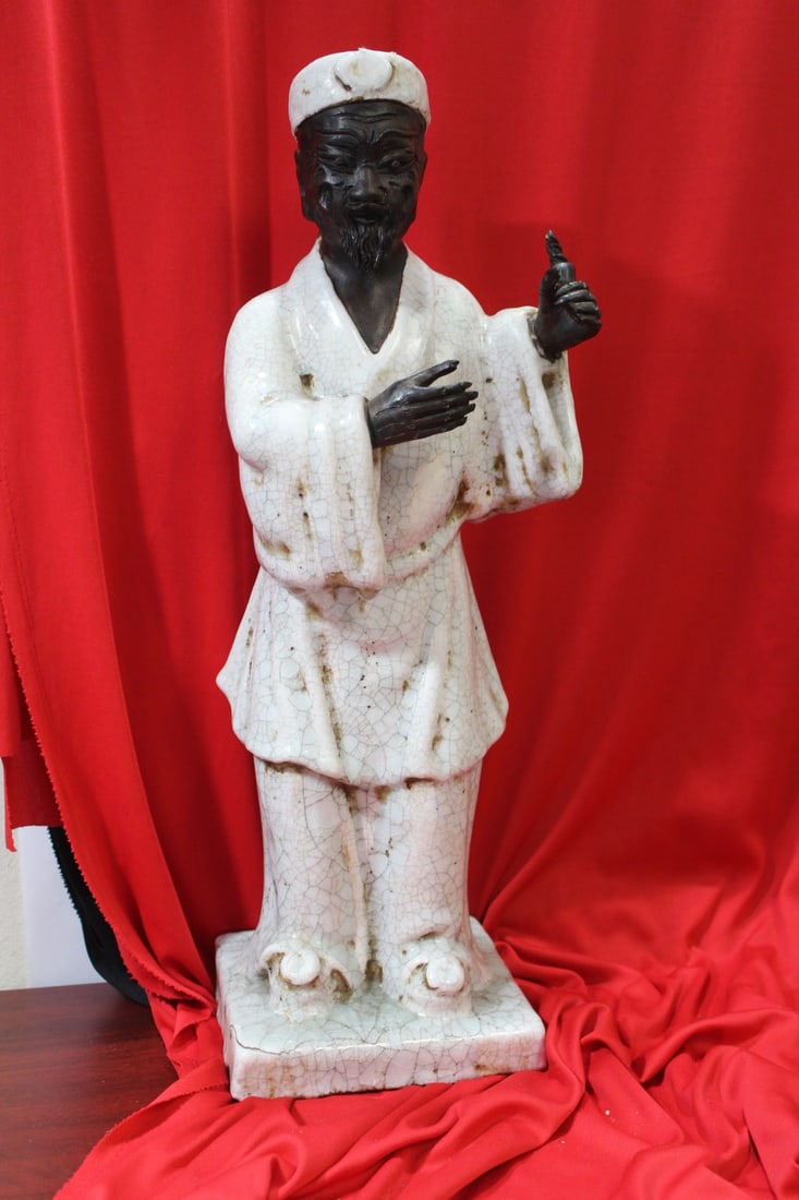 An Italian Terracota Black Man: 21 inches tall - please note: lost 2 fingers