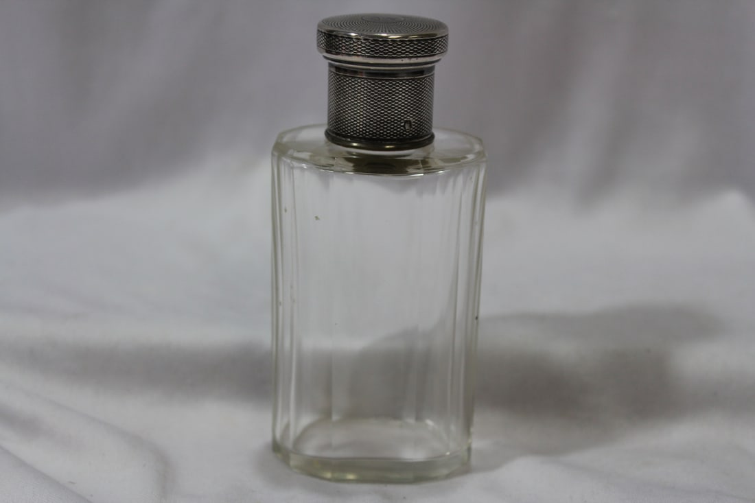 A Parfume Bottle with Sterling Top: 4 5/8" tall