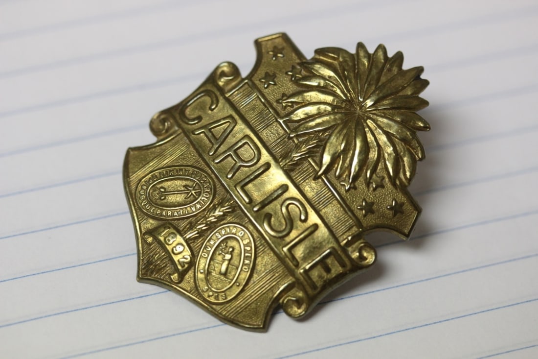 A Badge: Appears to be old, vintage