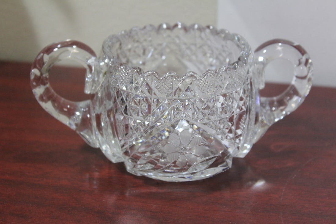 A Cut Glass Sugar Container: measures 6 1/2" from handle to handle