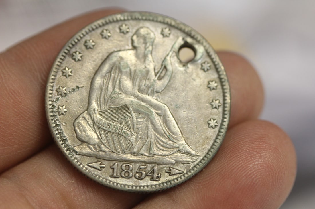 1854 Half Dollar: hole - very nice condition