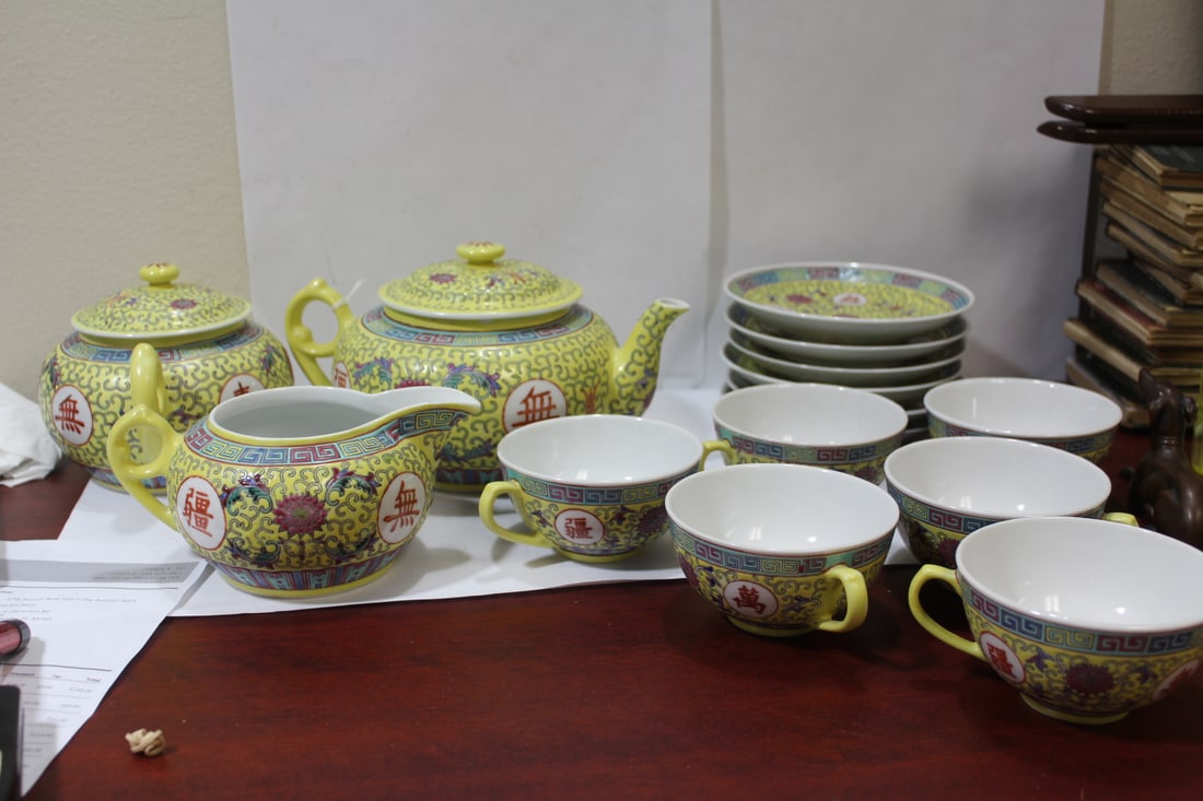 A Yellow Imperial Chinese Teaset: to include: teapot, creamer, sugar container and six cups with saucers - largest= 8 1/4" in diameter