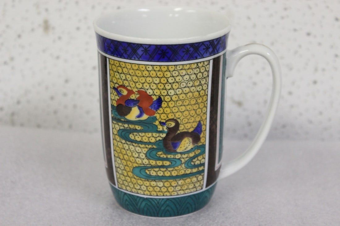 A Chinese or Oriental Cup: Signed on the bottom- nicely decorated - 4 inches tall