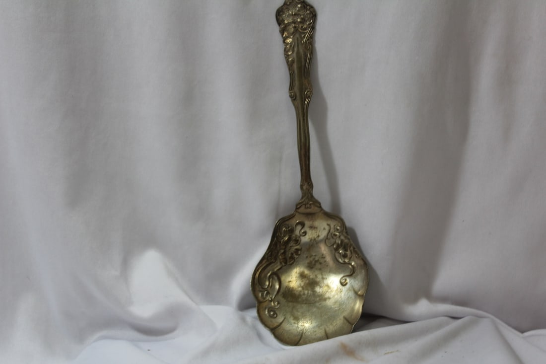An Ornate Silverplated Serving Spoon: 9 inches long