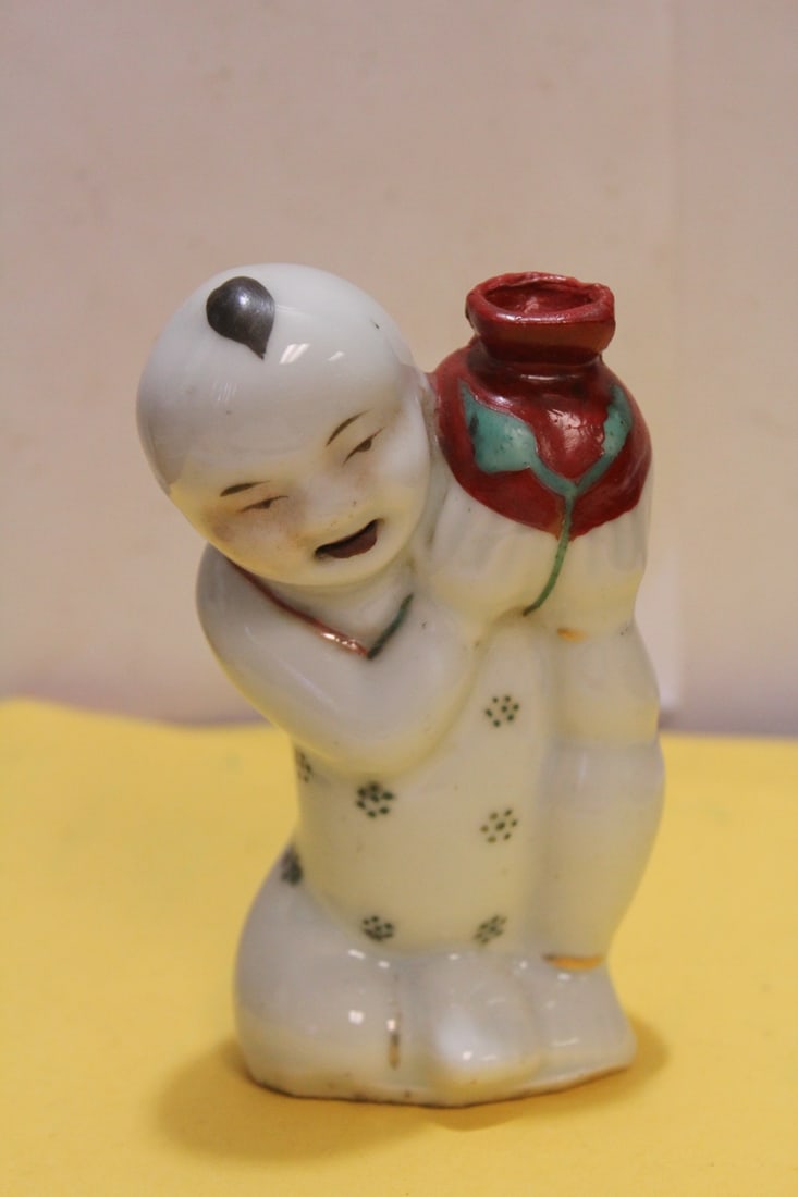 An Antique Chinese Ceramic Boy with Jug Figure: 19th century - top of jug is possibly restored - 5 inches tall