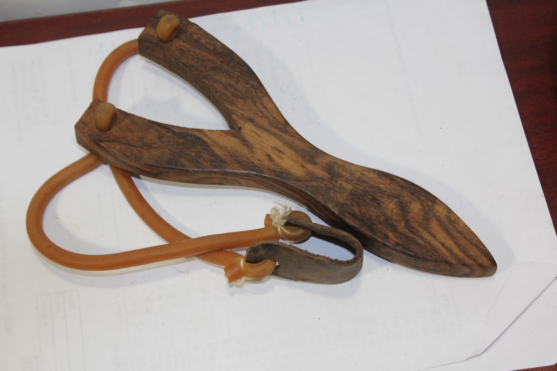 A Wooden and Rubber Sling: possibly home made - wooden part= 8 3/8" long