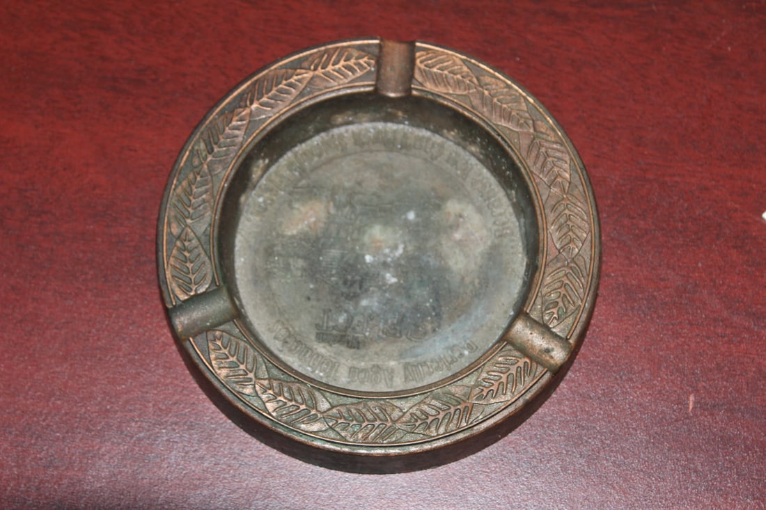 An Advertising Metal Ashtray: 4 7/8" in diameter