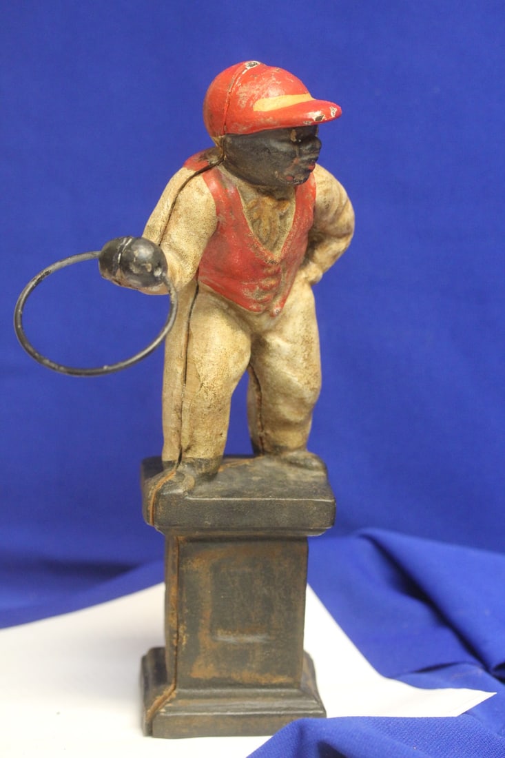 An Antique/VintageCast Iron Jockey: black Americana collectible - 11 inches tall