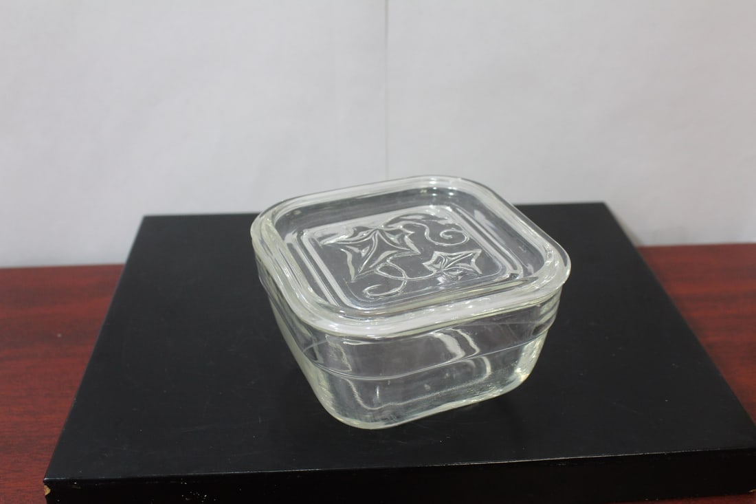 A Glass Container: 4 1/4" wide with lid