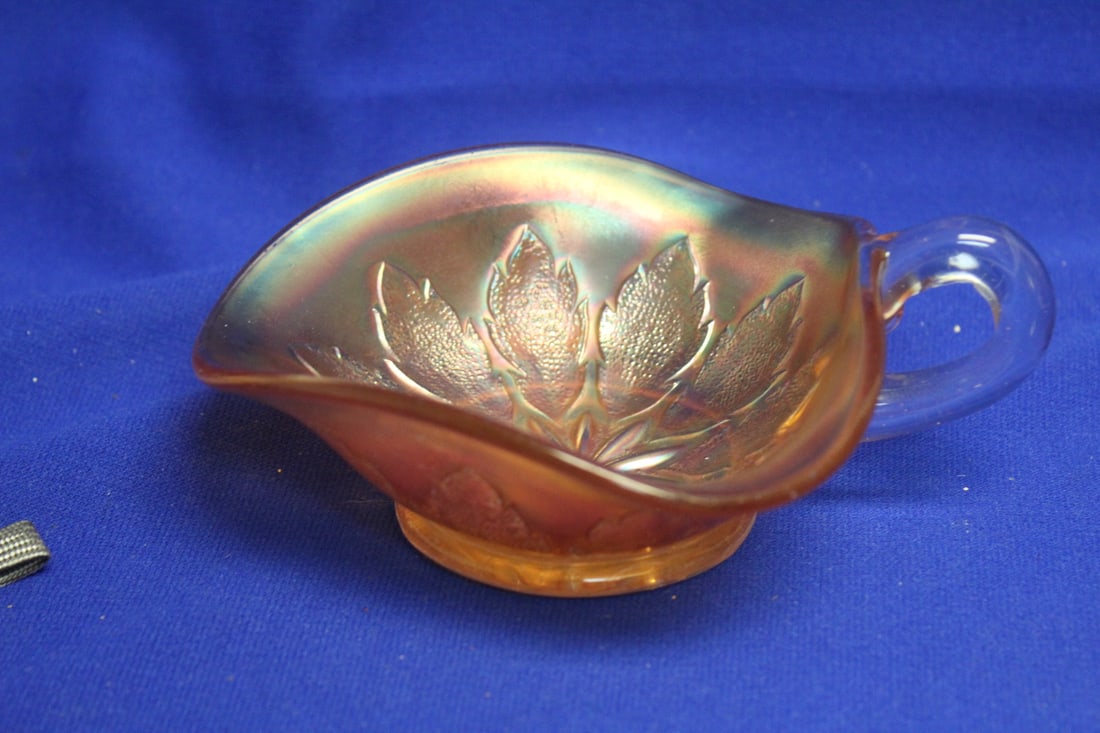A Carnival Glass One Handle Bowl: 6" in diameter