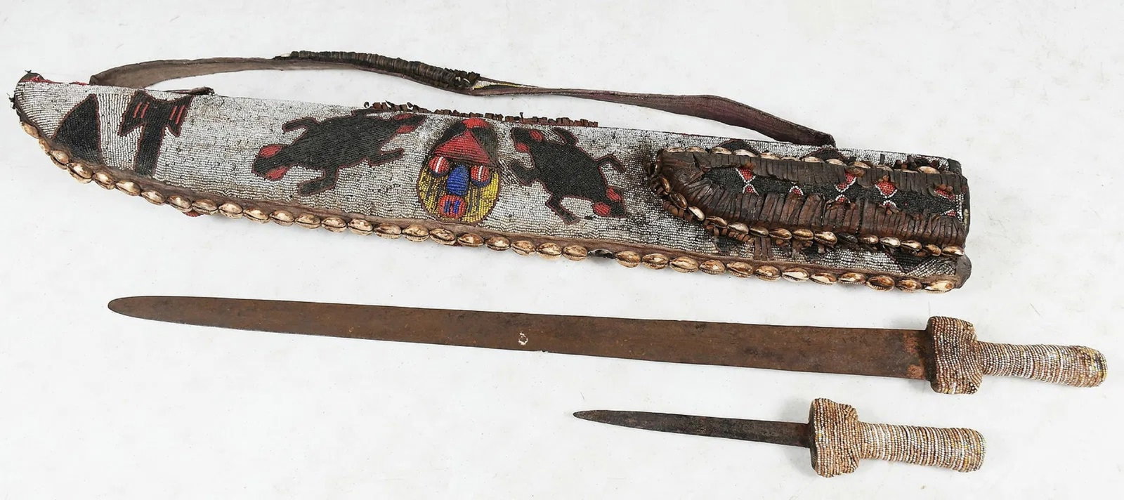Antique African Yoruba Sword and Knife with Case: beaded case sheath with a shoulder strap - please note: missing a couple of shells and a few missing beads - overall approximately 40" x 6" x 3"