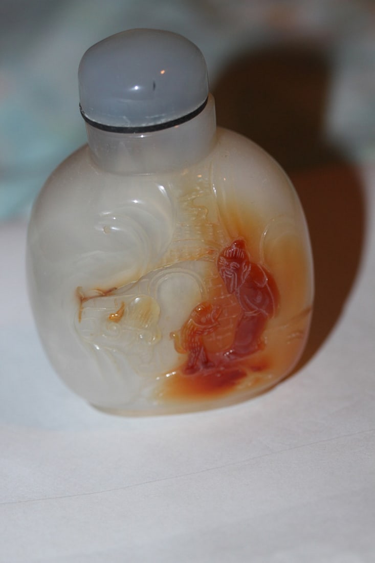 Carved Agate Snuff Bottleq: Chinese in origin. 2 3/4" tall including stopper.