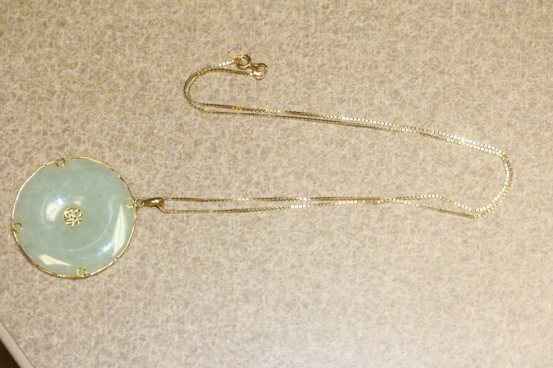 14 Karat and Jade Pendant with a 14Kt Gold Chain: overall 11" long when clapsed