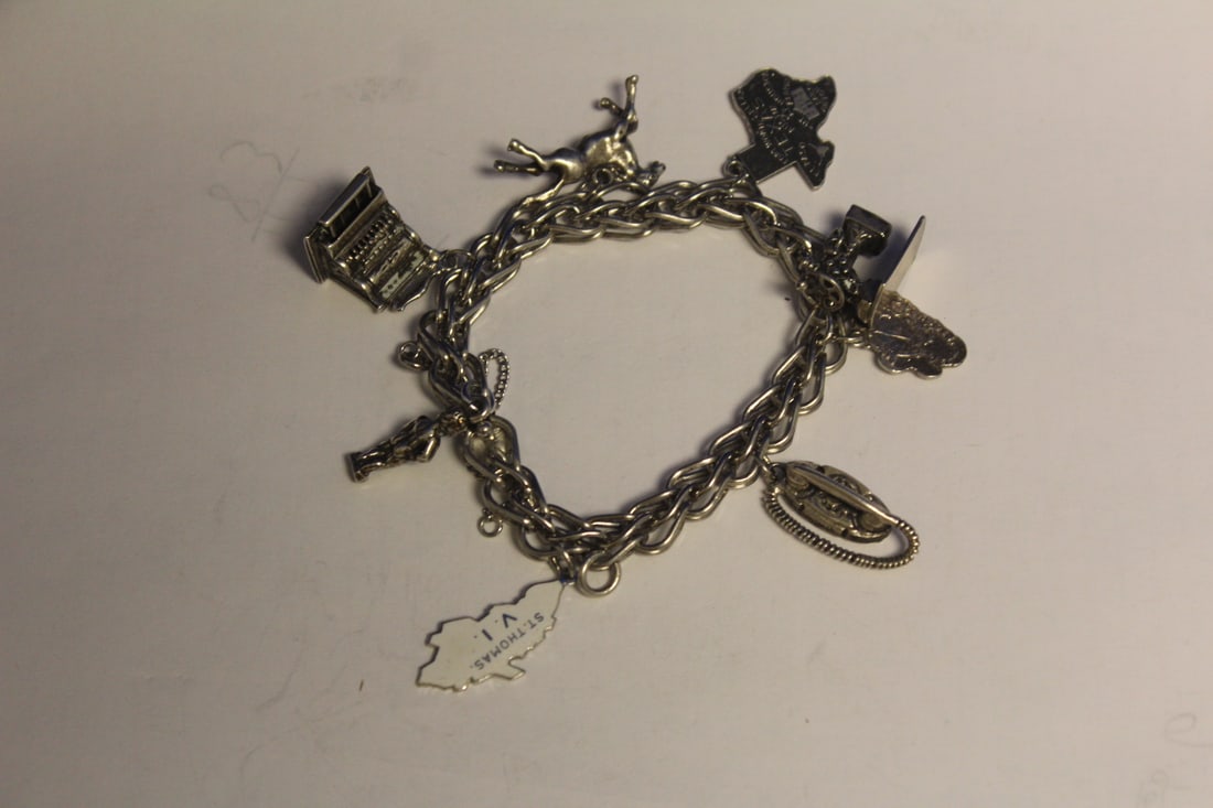 A Sterling Charm Bracelet: 3 1/4" long when clasped