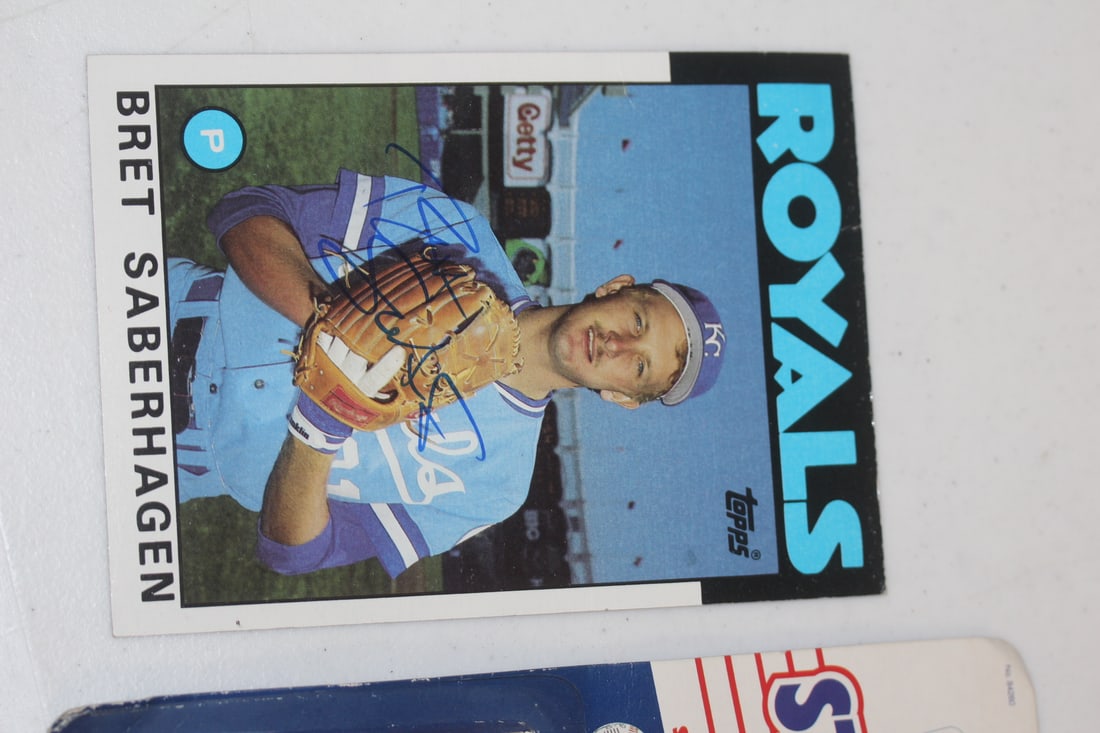 Lot of 2 Signed Bret Saberhagen Articles: starting lineup and a large baseball card