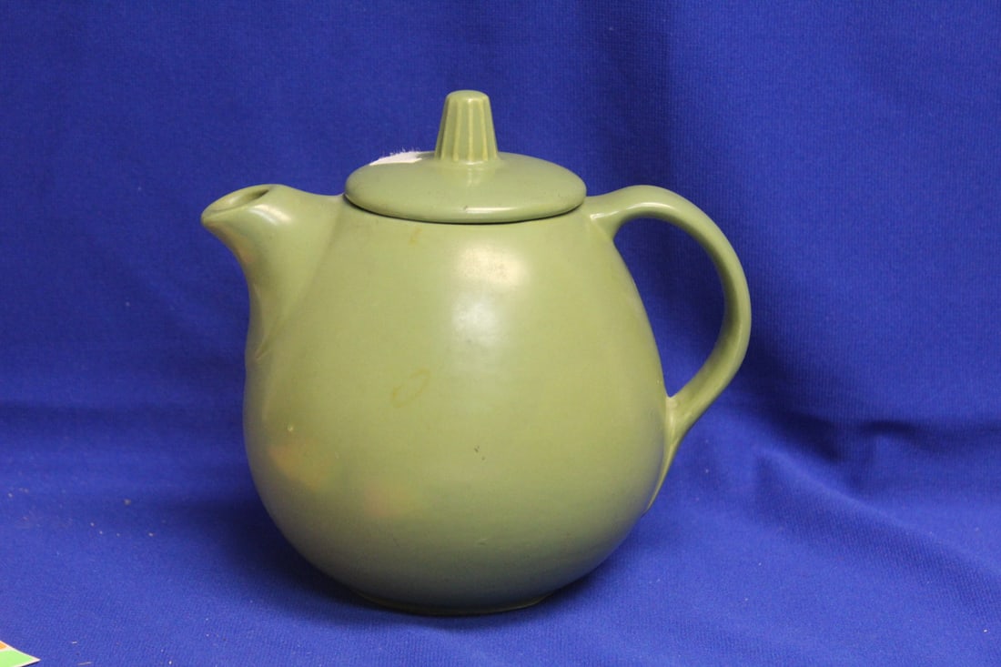 A Hull Pottery Teapot: please note: chip underneath the lid as shown, not noticeable when lidded - 7 inches tall
