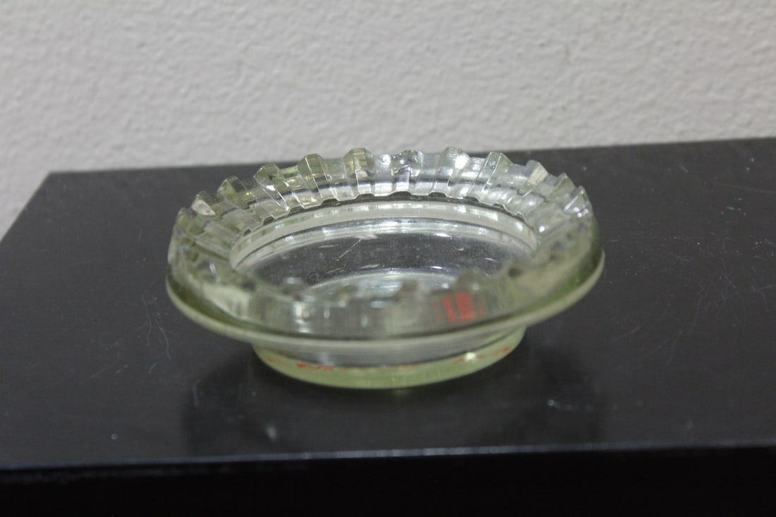 An Advertising Glass Ashtray: 4" in diameter