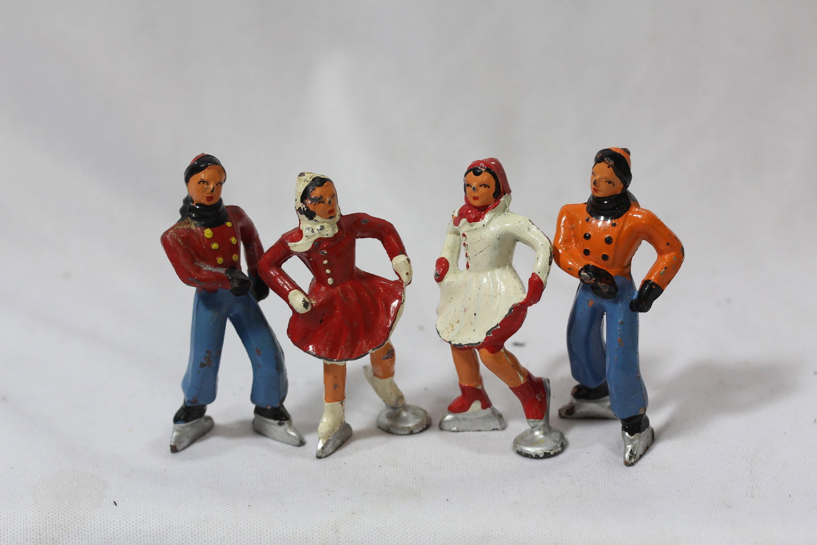 Lot of 4 Vintage Polychrome Small Figurines: approximately 2 3/4" tall each - all skaters