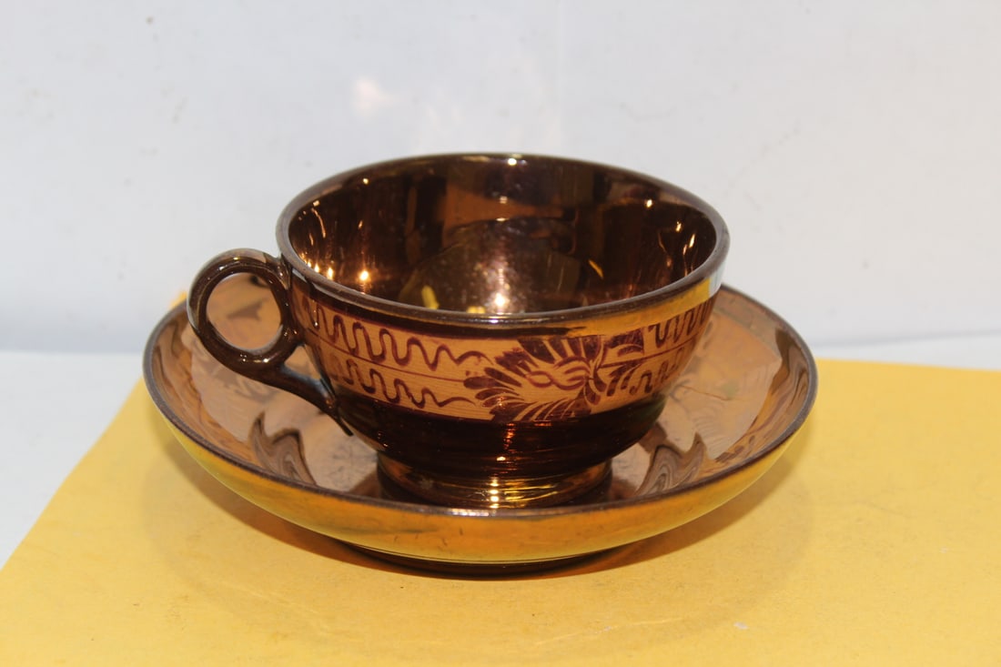 A Lusterware Cup and Saucer: saucer= 5 1/2" in diameter