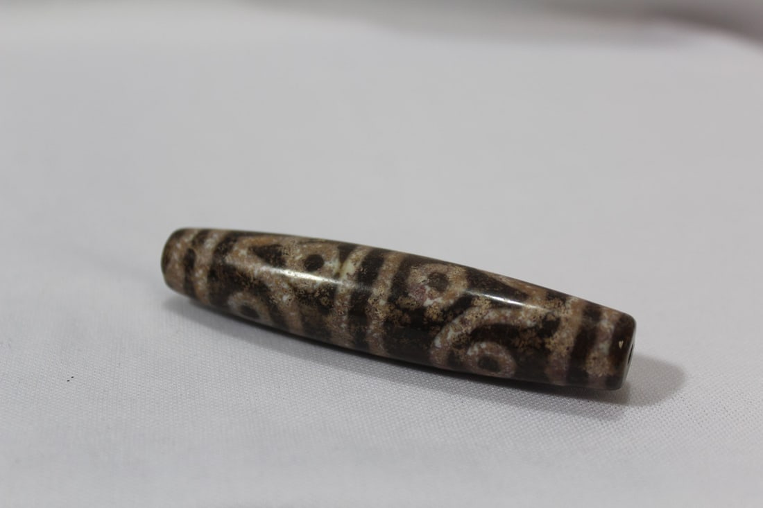 A Dzi Bead: 3" across and 3/4" wide