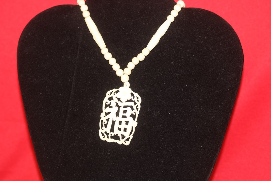 A Chinese Bone Necklace and Pendant: as shown