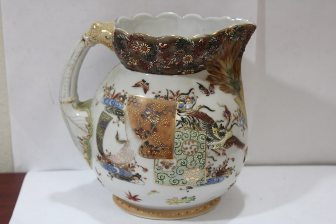 A Japanese Porcelain Pitcher: raised design - most likely Arita - well made and well designed - 7 1/2" tall