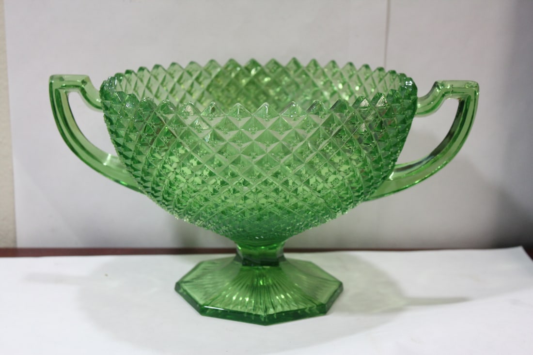 A Large Green Glass Center Bowl: appears ti be vaseline glass - measures 11" from handle to handle - 5 7/8" tall - rare