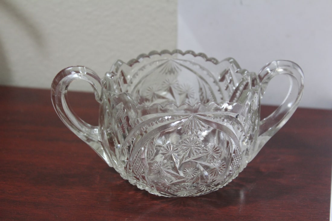 A Glass Sugar Container: measures 6 1/2" from handle to handle